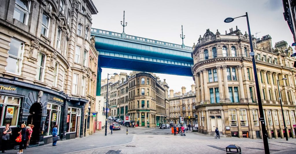 Street view of historic architecture and High Level Bridge in Newcastle, UK.